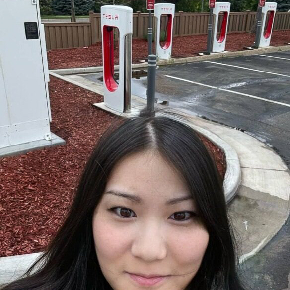 Woman in front of a tesla charging station